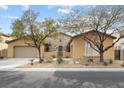 Charming single-story home with desert landscaping, a two-car garage, and an inviting stone facade at 7307 Iron Oak Ave, Las Vegas, NV 89113