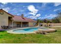 Enjoy the view of this pool and spa complemented by a spacious yard for relaxation and outdoor activities at 8880 W La Mancha Ave, Las Vegas, NV 89149