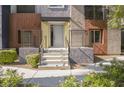 Inviting front entrance with stone steps, modern railings, and colorful exterior accents at 9050 W Tropicana Ave # 1178, Las Vegas, NV 89147