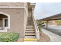 View of outdoor staircase leading to upper-level apartment units with covered parking visible at 9330 W Maule Ave # 225, Las Vegas, NV 89148