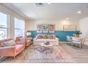 Bright living room with stylish pink chairs, sofa, dining area, and modern decor at 9379 Jade Mesa St # 46, Las Vegas, NV 89139