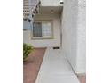 Exterior entry way with stairs, security door, window and concrete path leading to front door at 3318 N Decatur Blvd # 1059, Las Vegas, NV 89130