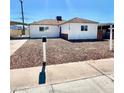 Charming single-story home with white exterior, brown roof, and minimal landscaping at 119 Cedar St, Henderson, NV 89015