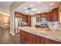 Beautiful kitchen with a spacious island, wood cabinets, stainless appliances, and granite counters at 1276 Spanish Armada Rd, Las Vegas, NV 89123