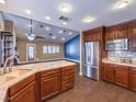 Open concept kitchen with stainless appliances, an island, granite countertops, and wood-look flooring at 1276 Spanish Armada Rd, Las Vegas, NV 89123