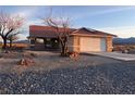Attractive single-story house with a clean desert landscape and attached garage at 1900 E Highland Ave, Pahrump, NV 89048
