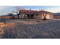 Inviting single-story home featuring desert landscaping and a covered front porch at 1900 E Highland Ave, Pahrump, NV 89048