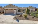 Charming single-story home featuring desert landscaping, secure gated entry, and a spacious two-car garage at 2715 Riceville Dr, Henderson, NV 89052