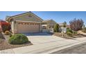 Single-story home featuring desert landscaping, secure gated entry, and a spacious two-car garage at 2715 Riceville Dr, Henderson, NV 89052