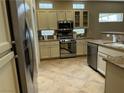 Bright kitchen with stainless steel appliances, granite countertops, and ample cabinet space at 2715 Riceville Dr, Henderson, NV 89052