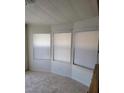 Bright room with carpeted floors and three windows, providing ample natural light at 3231 Comitan Ln, Las Vegas, NV 89122