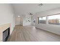 Bright living room boasts new floors, a cozy fireplace, and lots of natural light through large windows at 3519 Greenwick Dr, North Las Vegas, NV 89032