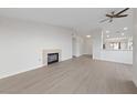 Spacious living room with light, new floors, fireplace, ceiling fan, and access to the kitchen at 3519 Greenwick Dr, North Las Vegas, NV 89032