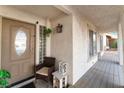 Inviting covered front porch with tasteful decor, chair, and tiled flooring at 3661 Margarita Way, Las Vegas, NV 89103
