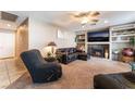 Comfortable living room with plush seating, a ceiling fan, and a decorative fireplace at 3661 Margarita Way, Las Vegas, NV 89103