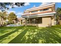 Luxury backyard featuring a large green lawn, a patio, and large windows at 42 Sawgrass Ct, Las Vegas, NV 89113