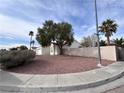 Corner lot showcasing a well-maintained yard with desert landscaping, mature trees, and a red tile roof at 4225 Bola Dr, North Las Vegas, NV 89032