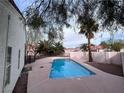 Backyard view highlighting a private swimming pool with ample deck space and lush desert landscaping at 4225 Bola Dr, North Las Vegas, NV 89032