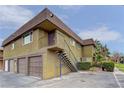 Exterior view of the building with a balcony and staircase, set against a partially cloudy sky at 4666 Monterey Cir # 4, Las Vegas, NV 89169
