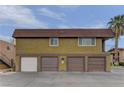 Two-story building with multiple garages and a well-maintained facade set under a bright sky at 4666 Monterey Cir # 4, Las Vegas, NV 89169