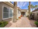 Inviting walkway with lush foliage and charming water feature leading to the entrance at 52 Via Paradiso St, Henderson, NV 89011