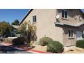 Exterior view of a home with desert landscaping and covered parking at 5273 Wave Dancer Ln, Las Vegas, NV 89118