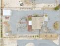 Expansive property showcasing a home with a fire pit, large garage, and desert landscaping at 620 W Leffner Dr, Pahrump, NV 89060