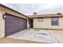 Wide shot of the two car garage, front door, and front-facing windows at 6309 Fairbanks Rd, Las Vegas, NV 89103