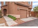 Two-story townhome featuring front door and a two-car garage at 693 Calamus Palm Pl, Henderson, NV 89011