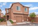Charming two-story townhome with a two-car garage and desert landscaping at 693 Calamus Palm Pl, Henderson, NV 89011
