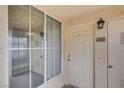 A well-lit entrance with a white door and storm door, side window, and lantern at 7119 S Durango Dr # 312, Las Vegas, NV 89113