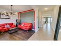 Bright living room featuring wood floors, an eye-catching light fixture, and modern decor at 748 Fast Green Way, Las Vegas, NV 89148