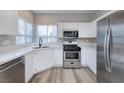 Beautiful kitchen with stainless steel appliances, wood flooring, and plenty of natural light at 7836 Pinnochio Ave, Las Vegas, NV 89131