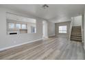 Open-concept living room with wood-look floors and a fireplace, offering a cozy and inviting space at 7836 Pinnochio Ave, Las Vegas, NV 89131