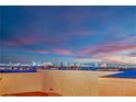 Enjoy a stunning city view from the rooftop terrace, illuminated by a breathtaking sunset sky at 8178 Eaton Hill St, Las Vegas, NV 89113