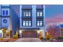 Modern three-story home showcasing a two-car garage, covered porch, and contemporary architectural details at 8178 Eaton Hill St, Las Vegas, NV 89113