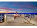 Relax on the expansive rooftop patio with comfortable seating and panoramic mountain and city views at 8178 Eaton Hill St, Las Vegas, NV 89113