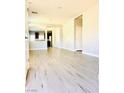 Bright, open living room with modern wood flooring and neutral paint at 8628 Vondel Park St, Las Vegas, NV 89148