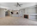 Spacious living room featuring tile floors, a cozy fireplace, and open access to the kitchen at 1004 Country Skies Ave, Las Vegas, NV 89123