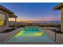 Stunning pool and spa combo with tranquil water features and mountain views beyond the wrought iron fence at 10086 Amethyst Hills St, Las Vegas, NV 89148