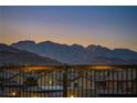 Sweeping neighborhood views against a mountain backdrop beyond a wrought iron fence at 10086 Amethyst Hills St, Las Vegas, NV 89148