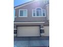 Spacious two-car garage door with stone accents and contemporary exterior at 1066 Slate Crossing Ln # 3, Henderson, NV 89002