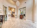 Elegant foyer with high ceilings, marble floors, a crystal chandelier, and stylish decor at 11593 Glowing Sunset Ln, Las Vegas, NV 89135