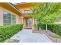 Inviting entrance featuring a double glass door, mature landscaping, and a stone walkway at 11593 Glowing Sunset Ln, Las Vegas, NV 89135