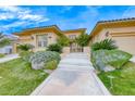 Charming home with a landscaped yard, white staircase and mature landscaping along the walkway to the front door at 11593 Glowing Sunset Ln, Las Vegas, NV 89135