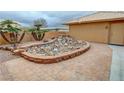 Backyard patio features unique rock garden and brick accents at 1211 Bourbon St, Pahrump, NV 89048