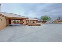 Wide driveway with covered area connecting the house and detached garage at 1211 Bourbon St, Pahrump, NV 89048
