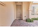A welcoming front door with brick flooring and an arched entryway at 12125 Las Hurdes Ave, Las Vegas, NV 89138