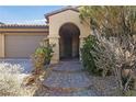 Arched front entry with brick steps leading to a secure gated door at 12125 Las Hurdes Ave, Las Vegas, NV 89138
