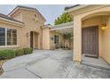 Stylish front porch with brick accents, covered area, and well-maintained landscaping at 2385 Orangeburg Pl, Henderson, NV 89044